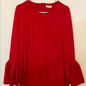 Red form fitting dress with bell sleeves